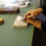 scraping the end of a piece of leather